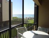 The patio and a view of the beach  at La Coquina C104